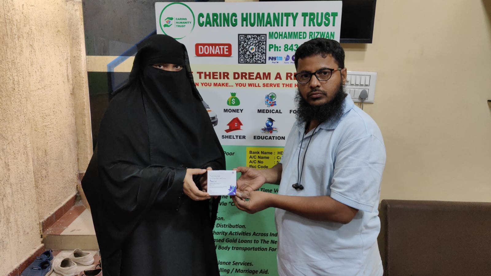 Medicine being handed to a woman at the Caring Humanity Trust office
